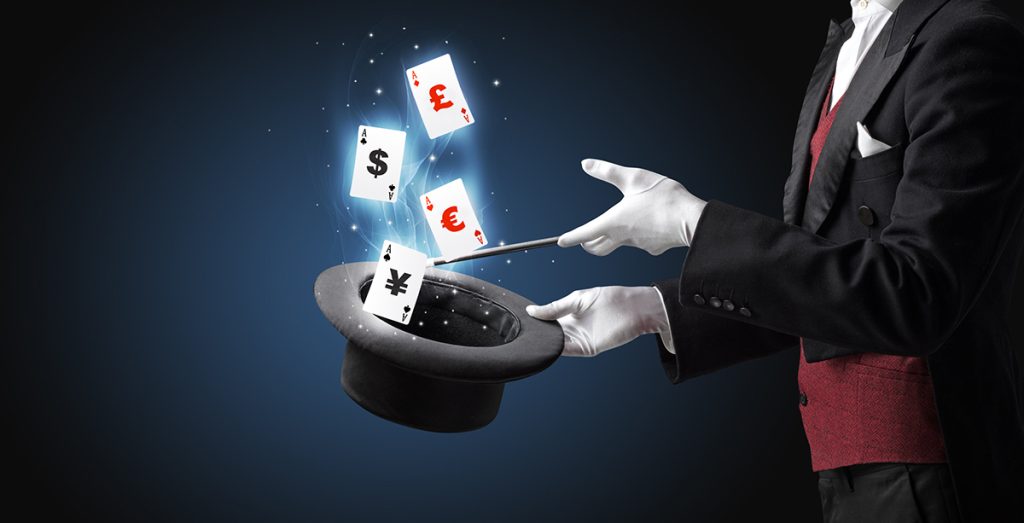 Magician performing a trick with wand and playing cards